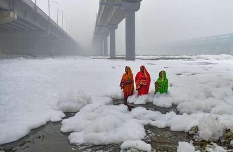 Toxic foam floating on the surface of the polluted Yamuna river.
